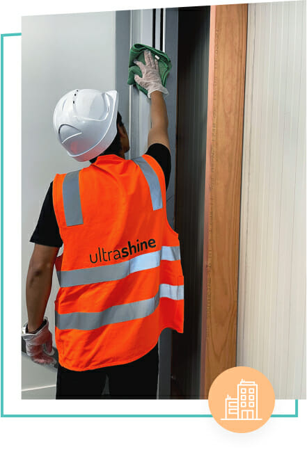 Ultra Shine employee cleaning door frame, post construction cleaning